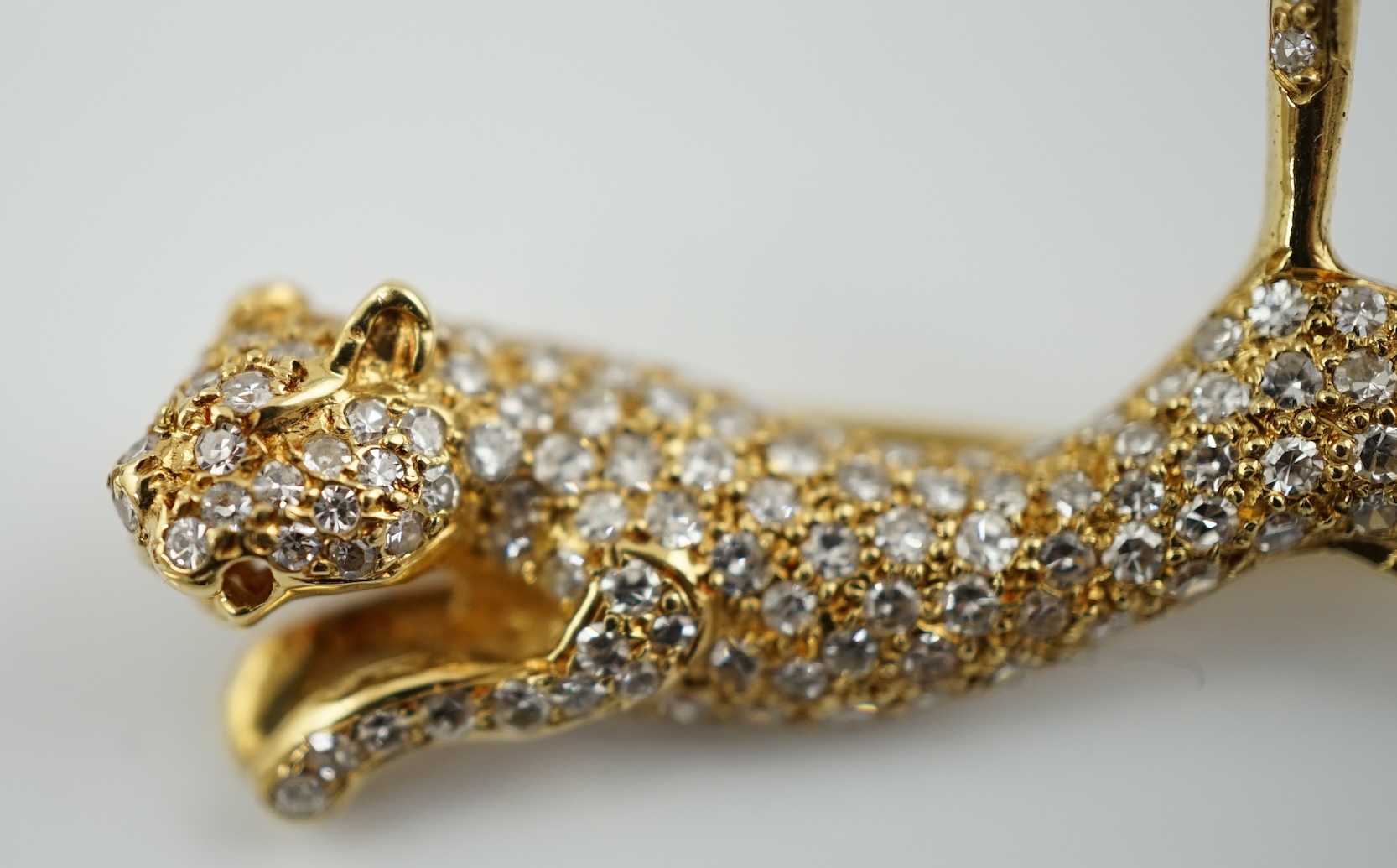 A gold and pave set diamond leaping panther brooch